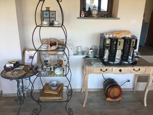 a room with two tables and a shelf with items on it at Agriturismo LaValleggia in Tovo San Giacomo