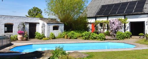 a house with a swimming pool in the yard at Lunkaberg Bed & Breakfast in Simrishamn