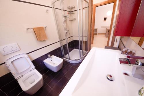 a bathroom with a shower and a toilet and a sink at 1Dest - Private Garden In Paradise in Riva del Garda