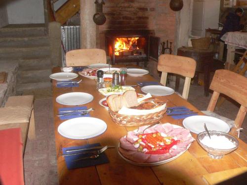 a wooden table with food on it with a fireplace at STARA PLEBANIA in Lądek-Zdrój