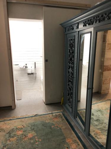 een badkamer met een glazen deur en een spiegel bij Casa vacanze Santa Lucia in Porto Cesareo