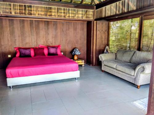 a bedroom with a large bed and a couch at Pool Mountain Moorea in Moorea