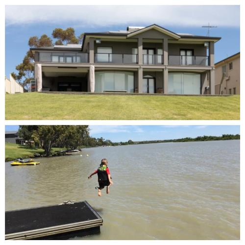 a woman jumping into the water in front of a house at River Devine in White Sands