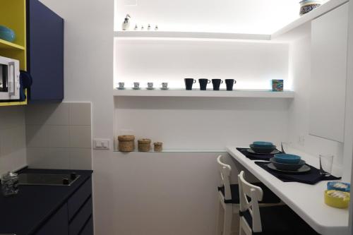 a kitchen with a stove and a white counter top at Lemon Suite in Naples