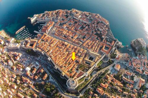 a large building with a clock on top of it at Apartments & Studios Scalini in Dubrovnik