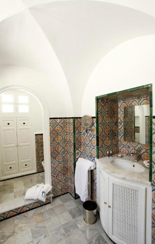a bathroom with a tub and a sink at La Villa Bleue-Sidi Bou Said in Sidi Bou Saïd