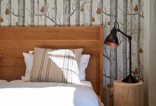 a bedroom with a bed with a wooden headboard at Hotel & Restaurant Linde in Münstertal