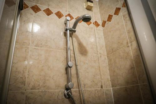 a shower with a shower head in a bathroom at VILLANOVA HOTEL in San Bonifacio