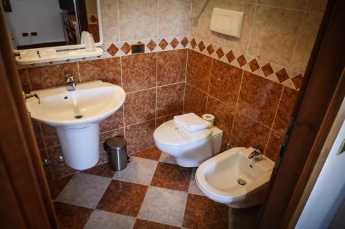 a bathroom with a sink and a toilet at VILLANOVA HOTEL in San Bonifacio
