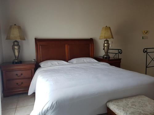 a bedroom with a large white bed with two night stands at Messina Resort Hotel in Kyparissia