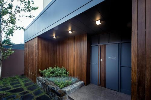 a house with wood paneling and a walkway at Soho Hotel Airport in Daegu