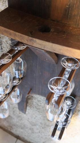 a group of wine glasses on a wooden table at Vineyard Cottage Zajc in Semič