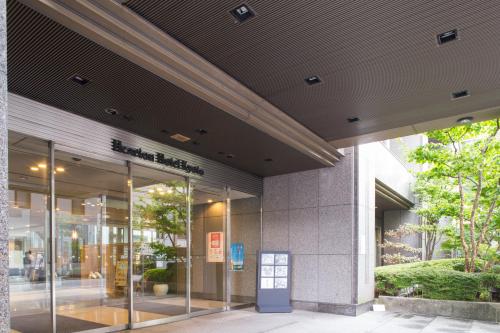 an entrance to a building with glass doors at Hearton Hotel Kyoto in Kyoto