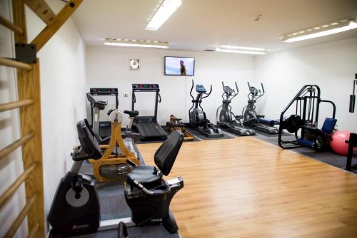 a gym with several treadmills and exercise bikes at The Hannafore Point Hotel in Looe