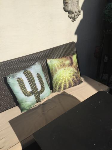 two pillows sitting on a bench in a room at B&B Con Ampère in Bruges