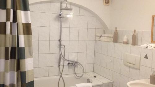 a bathroom with a shower and a tub at Pension Wielsch in Görlitz