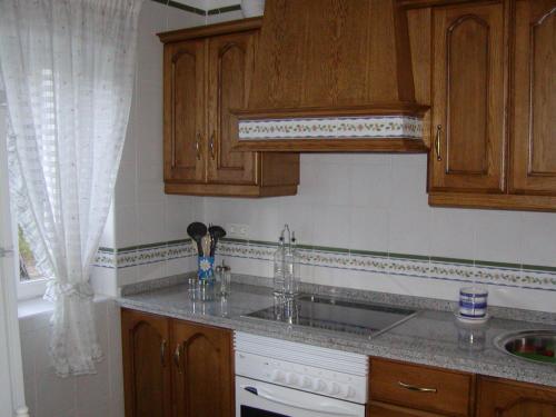 A kitchen or kitchenette at El Pinar De Villa Carmina