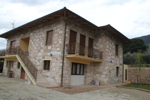a large brick building with stairs on the side of it at Le querce di mamre in Passaggio Di Assisi