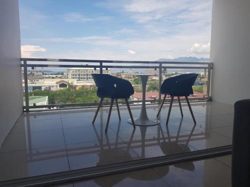 two chairs sitting on top of a glass window at Chequers Suites Subic Bay in Olongapo