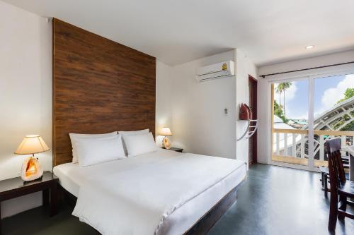 a hotel room with a bed and a dresser at PP Insula in Phi Phi Islands