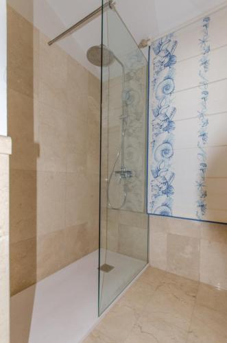 a shower with a glass door in a bathroom at Villa Meloneras in Meloneras