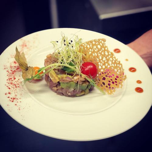 a white plate with food on top at Hôtel de la Paix in Bapaume