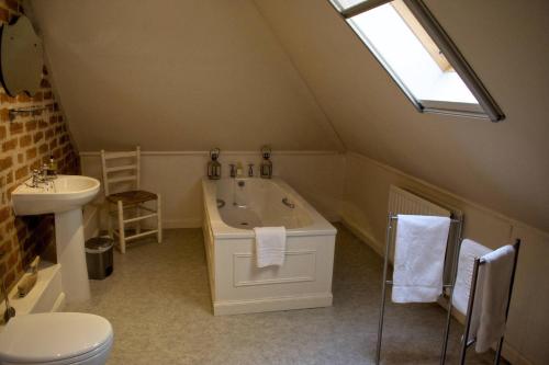 a bathroom with a white tub and a sink at The Old Pickle House in Kelso