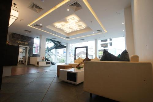 a living room with a couch and a table at The Terrace by Ladder Mgd by Citrine in Trivandrum