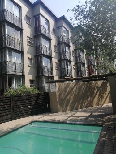 a building with a swimming pool in front of a building at The Bridgeview in Johannesburg