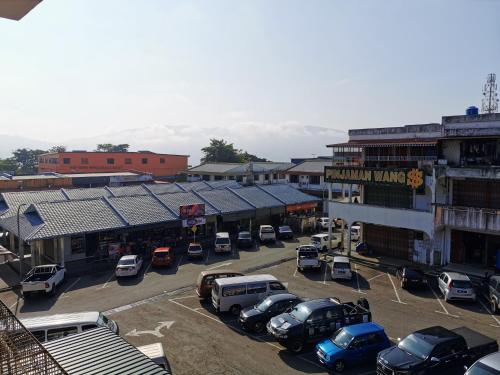 a town with cars parked in a parking lot at Lodge88 ( l l ) in Ranau