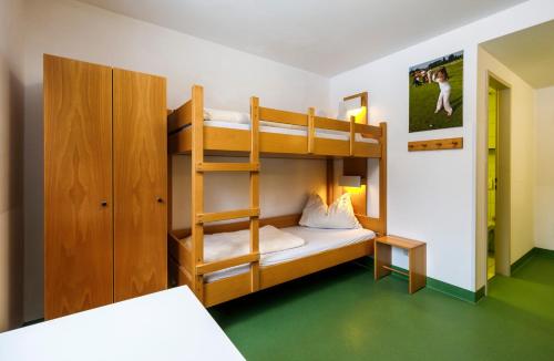 a bunk bed room with a bunk bed with a ladder at Jugendherberge Bad Tölz in Bad Tölz