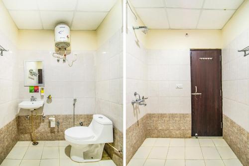 a bathroom with a toilet and a sink at FabExpress Elysian Grand - 3 kms from Chaudhary Charan Singh International Airport Lucknow in Lucknow