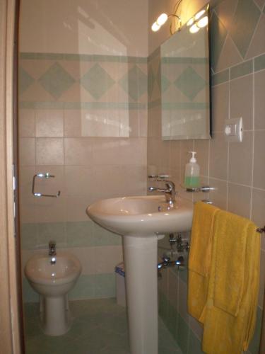 a bathroom with a sink and a toilet at Porto di Mare in Praia a Mare