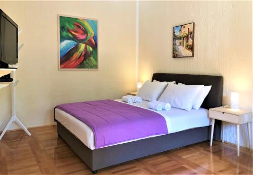 a bedroom with a bed with two stuffed animals on it at Cicki Apartments II in Podgorica