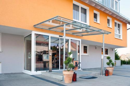 a building that has a patio door open at Hotel Merlin in Filderstadt