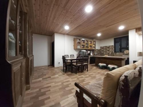 a living room with a couch and a table with chairs at Marigold Manor Homestay in Darjeeling