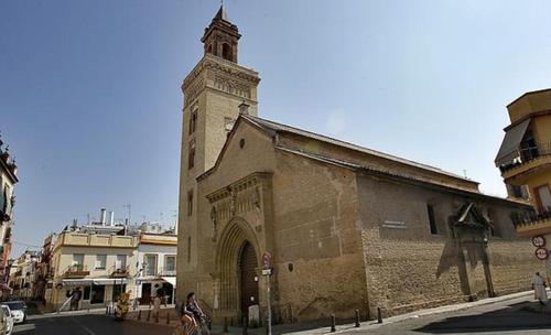 an old building with a clock tower on a street at COSY DOUBLE ROOM + PRIVATE BATHROOM SEVILLA CENTER in Seville