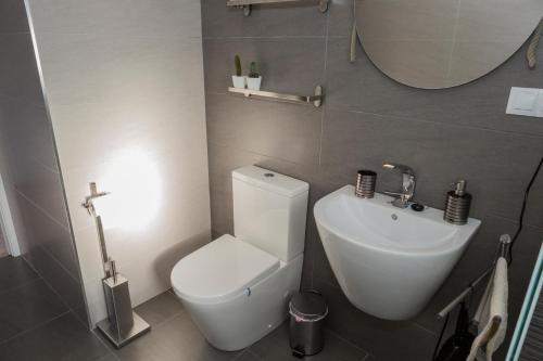 a bathroom with a white toilet and a sink at B&B Casa Josa in Ontinyent