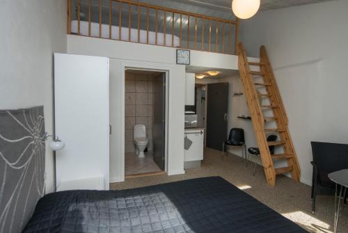 a bedroom with a loft bed and a bathroom at Ebeltoft Feriecenter in Ebeltoft