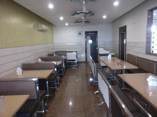 an empty dining room with tables and chairs at HOTEL SAHYOG & ROOMS in Surat