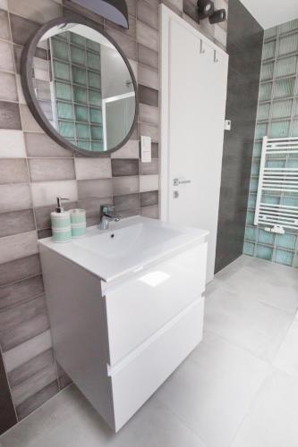 a bathroom with a white sink and a mirror at Tara Garden in Velika Gorica