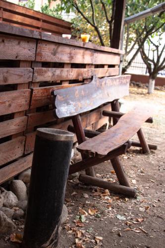 a wooden bench sitting next to a wooden wall at Sport Hostel Cluj in Cluj-Napoca