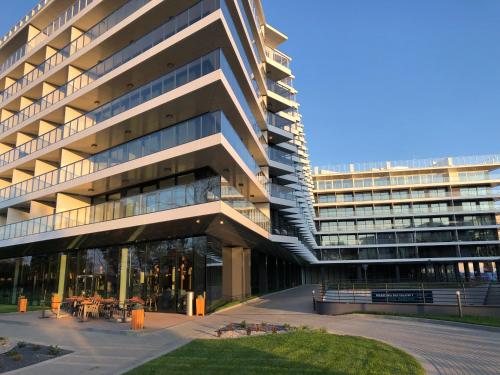 a large office building with a courtyard in front of it at Seaside - Apartamenty KOMFORT, widok na morze, Parking in Kołobrzeg