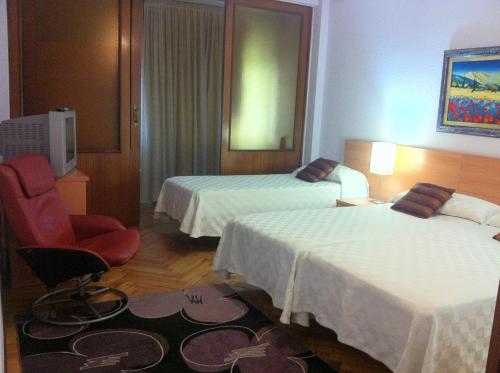 Ένα ή περισσότερα κρεβάτια σε δωμάτιο στο Hostal Del Carmen