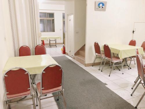a conference room with tables and chairs and a table at Chia Yun Homestay in Luodong
