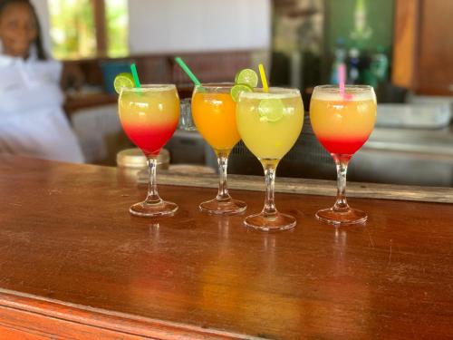 a group of four drinks sitting on a bar at Marcelo Beach Club in Lomé