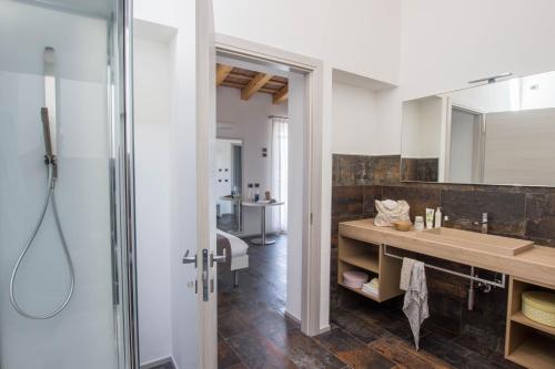 a bathroom with a sink and a mirror at Casanova Inn in Martignacco