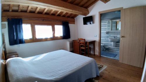 ロニーゴにあるAgriturismo Al Casaleのベッドルーム1室(ベッド1台付)、バスルーム(シンク付)