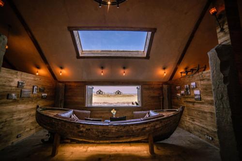 a large wooden room with a large wooden boat in it at Torfhús Retreat in Selfoss