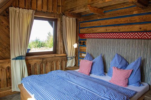 A bed or beds in a room at Chalupa Chalet Strachan